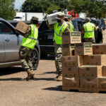 Louisiana National Guardsmen distributing rations to residents in Louisiana.